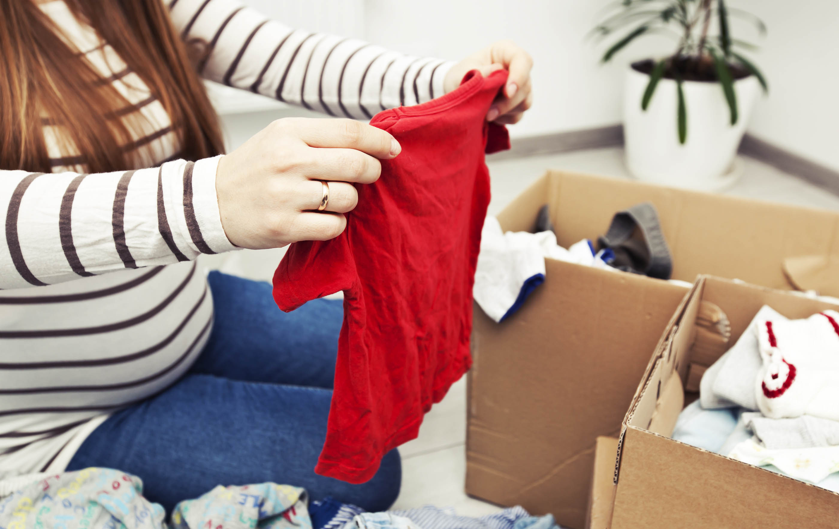 Sorting out second hand baby clothes (Image: SkyLine/Adobe Stock) 
