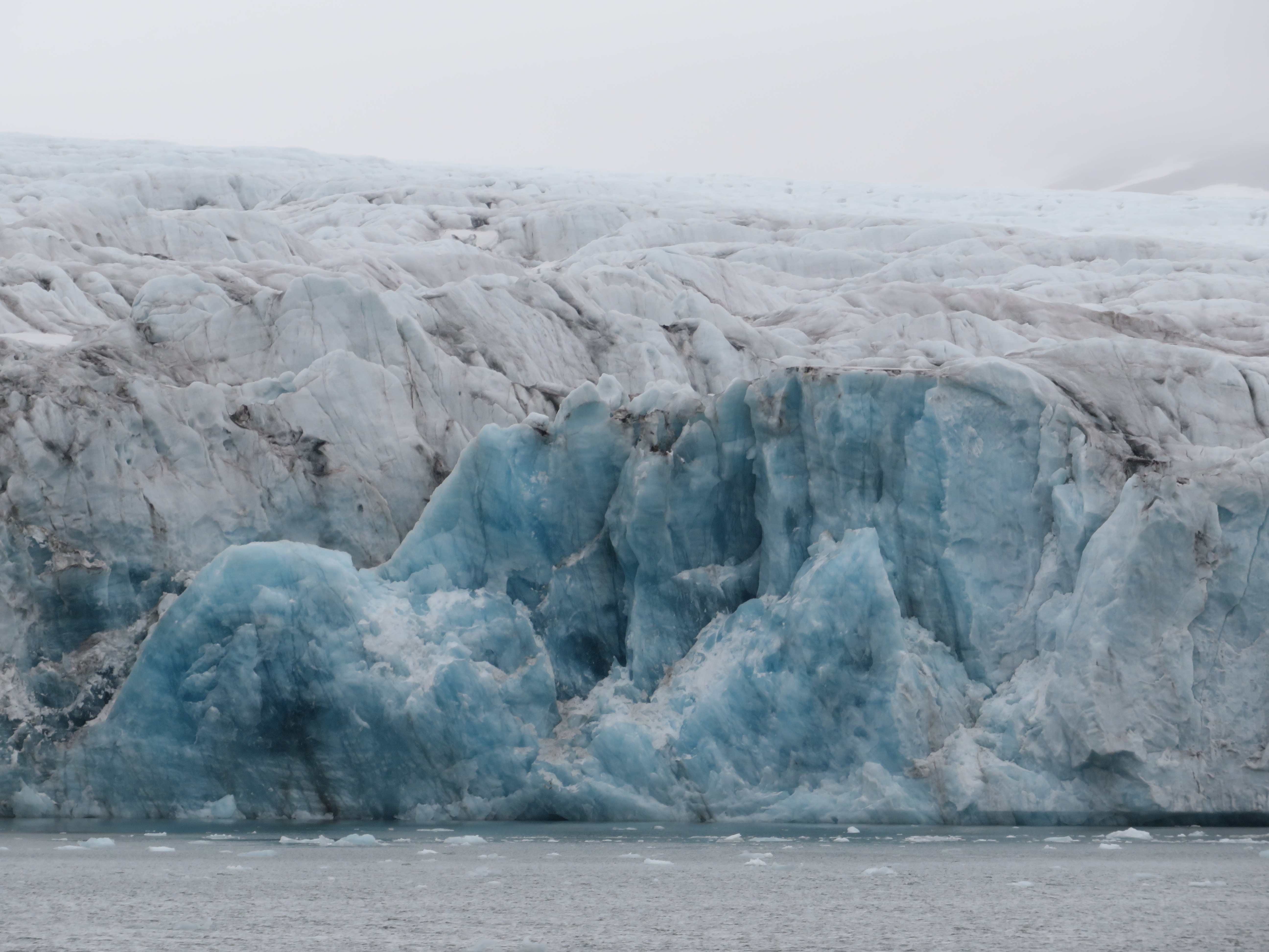 Calving events reveal pristine, blue ice at Hansbreen, Svalbard.
