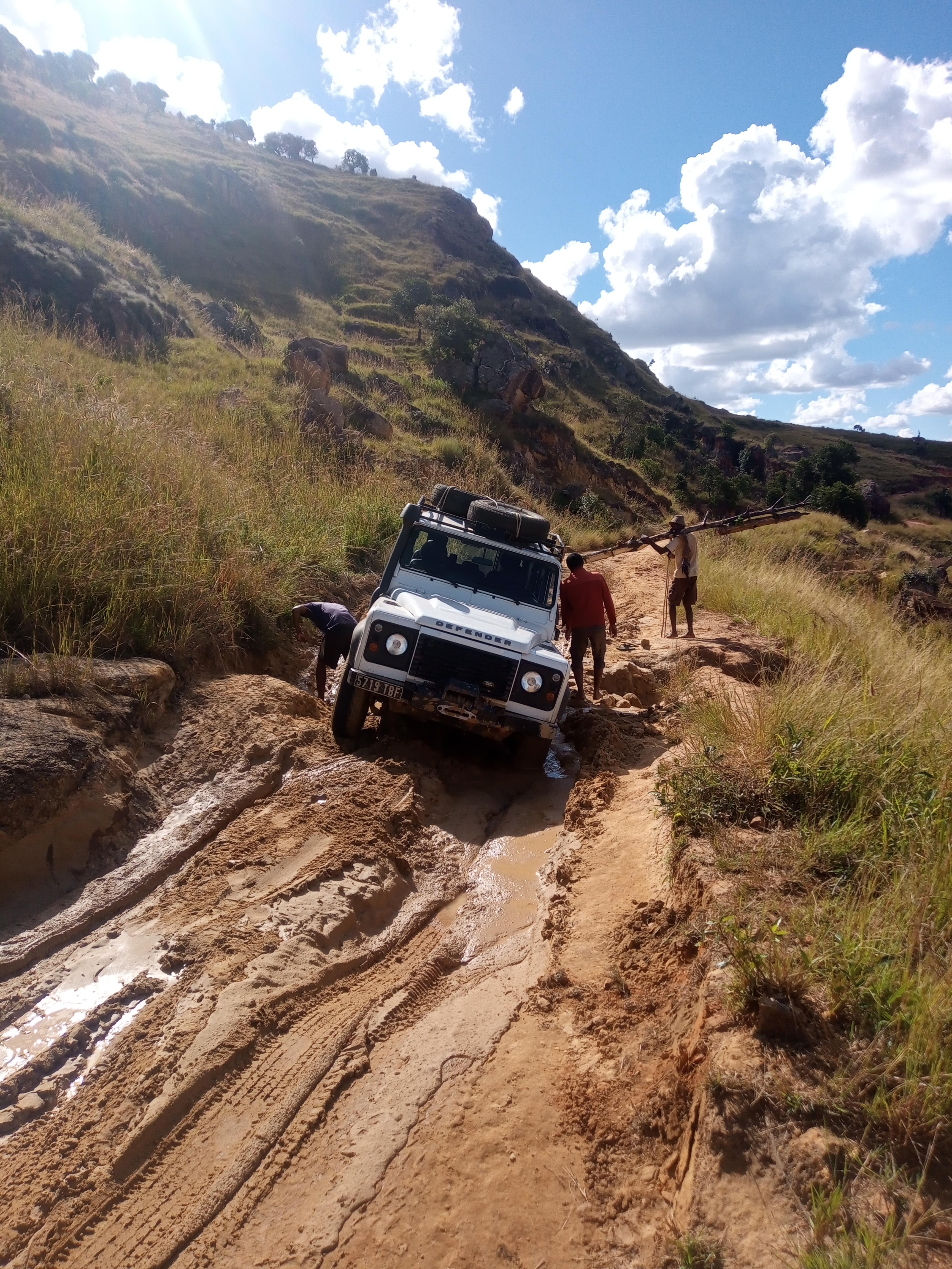 Conquering the treacherous road: our 4x4 vehicle valiantly struggles through the muddy terrain, and this is dry season! 